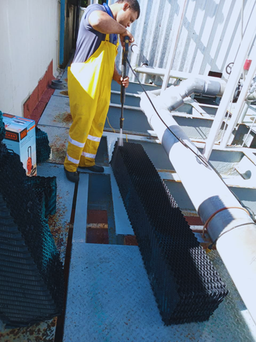 Técnico realizando limpieza física y química en sistema de enfriamiento.